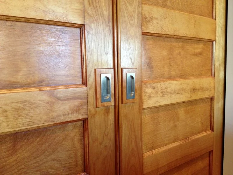 Historic pocket doors that were refinished and installed with new hardware.